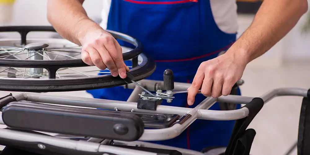 hands fixing a wheelchair